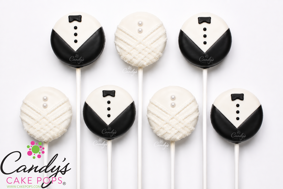 Six round cake pops decorated to look like tuxedo grooms, arranged on a white background. Three are dressed as black and white tuxedo jackets with small black bow ties and white buttons, and three are dressed as white brides dress with small white pearl details.