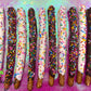 Festive Confetti Chocolate Covered Pretzel Rods - Candy's Cake Pops